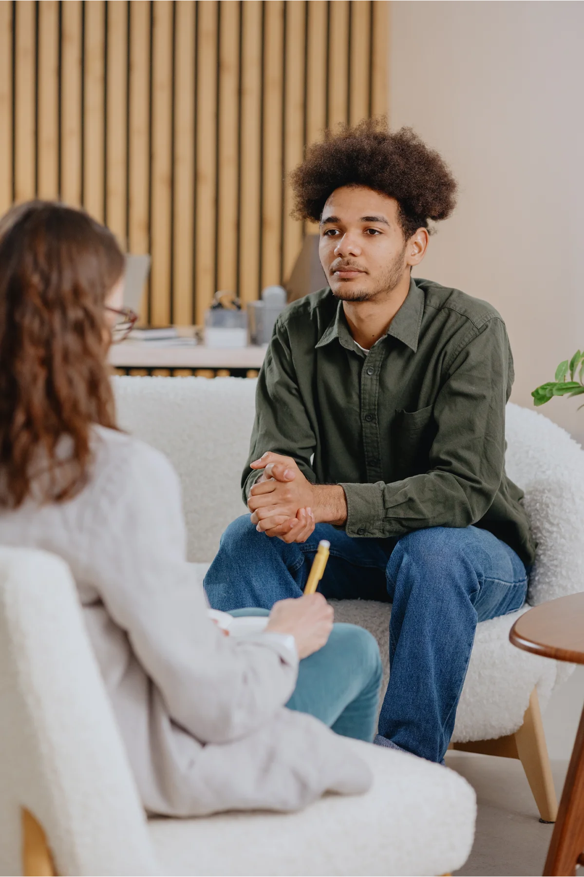 young man in consultation with psychologist is taking care of mental health. Psychotherapy for treatment of disorders and depression, insomnia. African American guy tells doctor about his problems